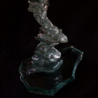 A twisted staircase glass miniature made from broken green glass with a flat glass top